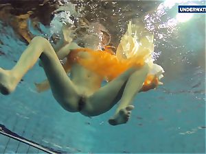 Yellow and red clad teen underwater
